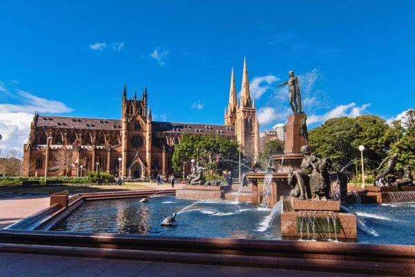 The Archibald Fountain brings bronze figures and moving water into Hyde Park, with St Mary's behind it.