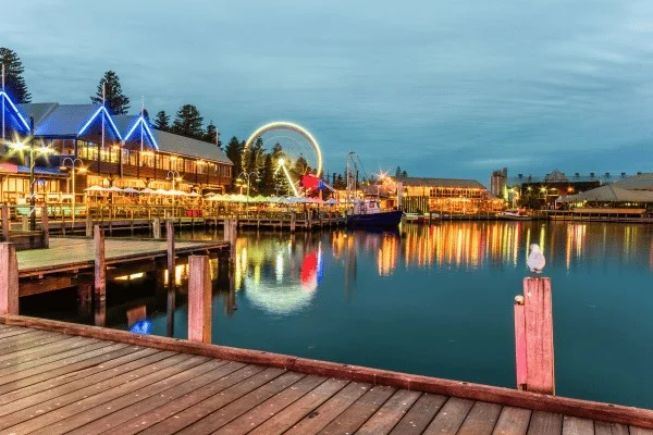 Fremantle's illuminated harbour offers a present day contrast to the dangerous voyages studied in its maritime collections.