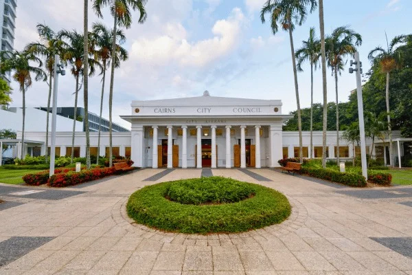 A civic building in Cairns; the city’s history also includes less visible farming and trading communities.
